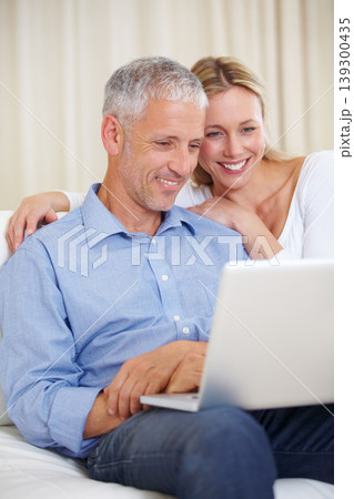Mature couple, laptop and watching with laugh, conversation and living room couch. Social media, technology and communication with family, man and woman with connection, streaming and happy 139300435