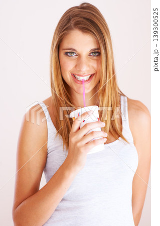 Woman, portrait and drink cup of soda, fizzy cola and ice cold milkshake in studio on white background. Thirsty, happy and young girl sip on straw for takeaway smoothie, juice and fast food beverage 139300525