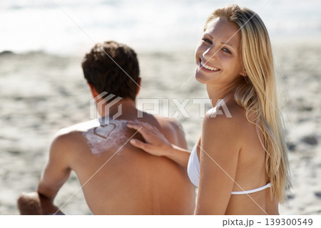 Beach, happy couple or apply sunscreen heat on vacation, holiday or weekend trip travel together. Love, uv protection or suncream application for summer skin safety, solar security or SPF sunblock. 139300549