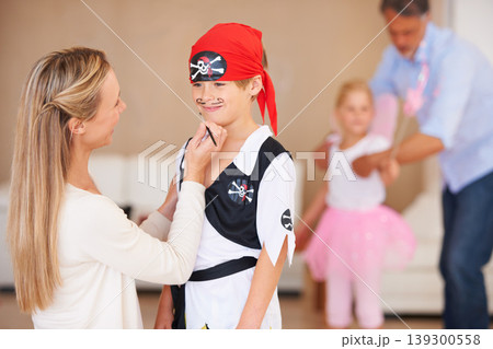 Son, pirate costume and halloween with mother in home, face paint and happiness in childhood. Boy, smile and house birthday with party clothes by woman, love family and celebration together with care Son, pirate costume and halloween with mother in home, face paint and happiness in childhood. Boy, smile and house birthday with party clothes by woman, love family and celebration together with care 139300558