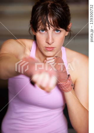 Boxing, punch and portrait of woman with fitness, power and fearless training challenge in gym. Strong body, muscle and face of boxer, athlete or girl with fist up for confidence in competition fight 139300732