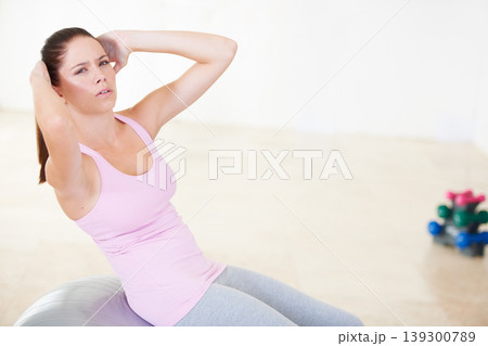 Portrait, health and woman with abdominal exercise, core training and progress with endurance, workout and challenge. Face, person or girl with dedication in a wellness studio, dumbbells and crunches Portrait, health and woman with abdominal exercise, core training and progress with endurance, workout and challenge. Face, person or girl with dedication in a wellness studio, dumbbells and crunches 139300789