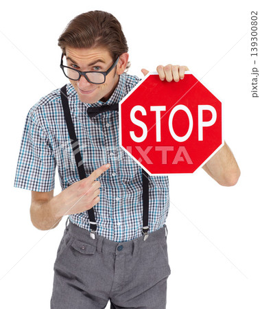 Portrait, stop sign and a man nerd pointing in studio isolated on a white background to direct traffic. Safety, law or legal with a young geek in glasses showing a road warning for speed danger 139300802