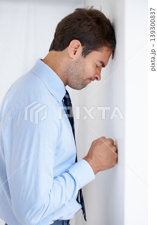 Frustrated businessman, stress and mistake in debt, anxiety or burnout with fist on wall at office. Upset man or employee in financial crisis, anger management or mental health problems at workplace Frustrated businessman, stress and mistake in debt, anxiety or burnout with fist on wall at office. Upset man or employee in financial crisis, anger management or mental health problems at workplace 139300837