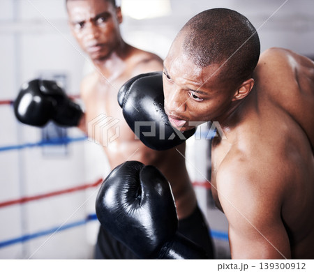 Boxing, black man and sparring partner with punch in ring together with fitness, power strike and training challenge. Strong body, hit and boxer in gloves, fearless and confident in competition fight Boxing, black man and sparring partner with punch in ring together with fitness, power strike and training challenge. Strong body, hit and boxer in gloves, fearless and confident in competition fight 139300912