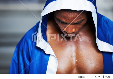 Black man, robe and boxing champion getting ready for fight, challenge or sports competition at gym or ring. Serious African male person, fighter or boxer in preparation for MMA match or game start Black man, robe and boxing champion getting ready for fight, challenge or sports competition at gym or ring. Serious African male person, fighter or boxer in preparation for MMA match or game start 139301206