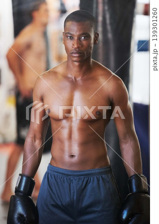 Boxing, gloves and portrait of serious black man with fitness, power and training for challenge in club. Strong body, muscle workout and boxer in gym, athlete with confidence .and competition fight. 139301260