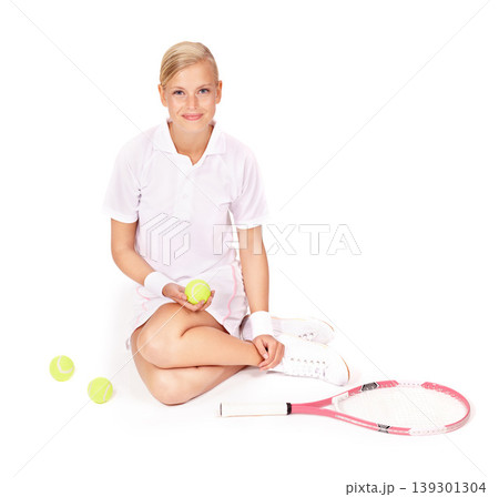 Portrait, woman and sitting with tennis balls, racket and skill for sports, competition and break in studio on white background. Happy professional athlete on floor with bat for performance for match Portrait, woman and sitting with tennis balls, racket and skill for sports, competition and break in studio on white background. Happy professional athlete on floor with bat for performance for match 139301304