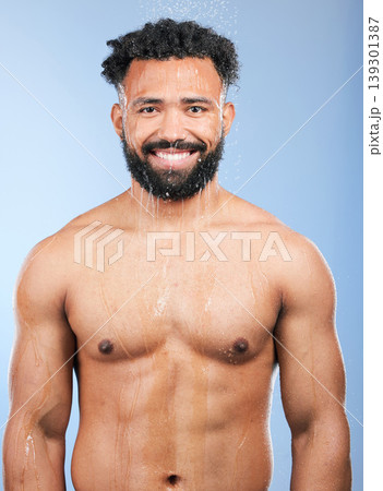 Shower, cleaning and water with man portrait and smile from skincare and morning routine. Bathroom, cosmetics and male model in a studio with blue background and dermatology for wellness and wash Shower, cleaning and water with man portrait and smile from skincare and morning routine. Bathroom, cosmetics and male model in a studio with blue background and dermatology for wellness and wash 139301387