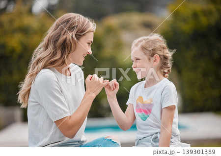 Outdoor, swear and mother with girl, pinky promise and relax with happiness, bonding or commitment link. Family, mama or kid with hand gesture, support or love in a park, secret or nature with trust Outdoor, swear and mother with girl, pinky promise and relax with happiness, bonding or commitment link. Family, mama or kid with hand gesture, support or love in a park, secret or nature with trust 139301389
