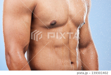 Torso water drops, body shower and person wet, grooming or morning self care, maintenance or cleaning stomach. Bathroom liquid, bath or studio model hygiene, strong abdomen or wash on blue background Torso water drops, body shower and person wet, grooming or morning self care, maintenance or cleaning stomach. Bathroom liquid, bath or studio model hygiene, strong abdomen or wash on blue background 139301402