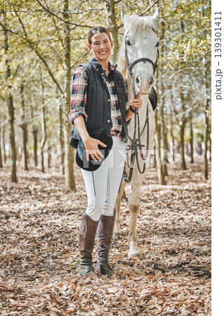 Portrait of happy woman with horse standing in forest, nature and love for animals, pets or dressage with trees. Equestrian sport, jockey or rider in woods for adventure, pride and smile on face. 139301411