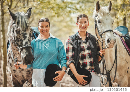 Smile, nature and portrait of women with horses in forest training for race, competition or event. Happy, animal and young female people with stallion pets outdoor in woods for equestrian practice. Smile, nature and portrait of women with horses in forest training for race, competition or event. Happy, animal and young female people with stallion pets outdoor in woods for equestrian practice. 139301456