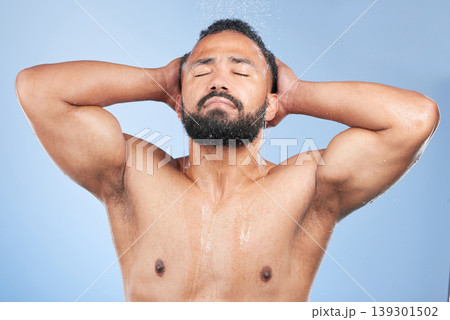 Bath water, shower and man wet, grooming and morning self care maintenance, bathroom body cleaning or spa salon wellness. Skincare liquid wash, eyes closed or studio person hygiene on blue background Bath water, shower and man wet, grooming and morning self care maintenance, bathroom body cleaning or spa salon wellness. Skincare liquid wash, eyes closed or studio person hygiene on blue background 139301502