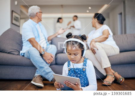 Child, listening to headphones and tablet with parents fighting in lounge, argue and shout for problems. Broken home, trauma and mental health issue for kid, hear or streaming and grandparents 139301685