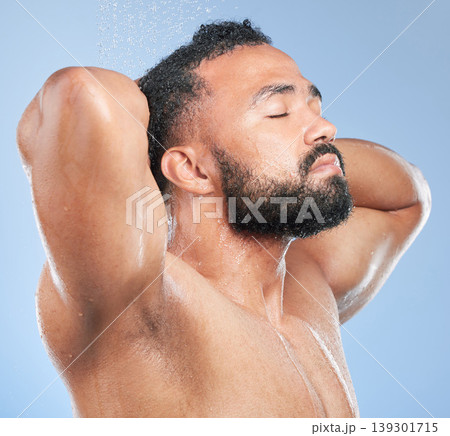 Shower, cleaning splash and relax man with shampoo and calm from water, skincare and morning routine. Bathroom, cosmetics and model in studio with blue background and dermatology for wellness wash Shower, cleaning splash and relax man with shampoo and calm from water, skincare and morning routine. Bathroom, cosmetics and model in studio with blue background and dermatology for wellness wash 139301715