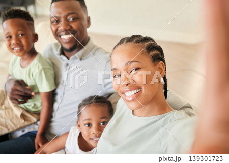 Selfie, happy family and children in home for social media, profile picture or post. Black people, little girl and boy with smile in excitement for memory, bonding and together on sofa in living room Selfie, happy family and children in home for social media, profile picture or post. Black people, little girl and boy with smile in excitement for memory, bonding and together on sofa in living room 139301723