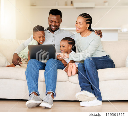 Happy family, laptop and streaming with smile on sofa for entertainment, video or movie. Black man, woman and children in laugh for funny joke on technology by internet, website or app in living room Happy family, laptop and streaming with smile on sofa for entertainment, video or movie. Black man, woman and children in laugh for funny joke on technology by internet, website or app in living room 139301825