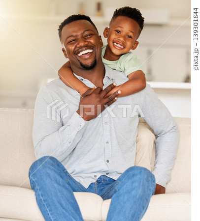 Dad, son or hug on sofa in portrait, love or happy family with wellness in living room. Black people, man and child together with smile face, care bonding and weekend with gratitude support in house Dad, son or hug on sofa in portrait, love or happy family with wellness in living room. Black people, man and child together with smile face, care bonding and weekend with gratitude support in house 139301844