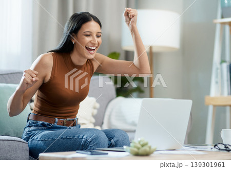 Woman, winner and yes on laptop and sofa for online education, e learning or virtual school results at home. Excited student with fist, cheers and reading email or news of winning on her computer 139301961