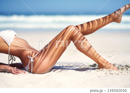 Woman, legs and bikini on beach sand for tanning vacation, resort relax for paradise travel. Female person, feet and swimsuit for outdoor costal trip for summer journey or sea sun, clean air at ocean Woman, legs and bikini on beach sand for tanning vacation, resort relax for paradise travel. Female person, feet and swimsuit for outdoor costal trip for summer journey or sea sun, clean air at ocean 139302030