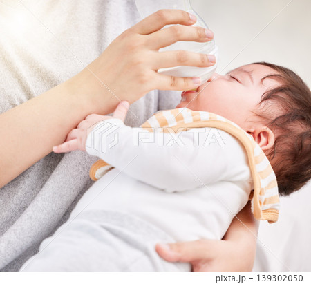 Mother, baby and feeding bottle with love and care or nursing with rest or nap in comfort and peace. A woman and girl child asleep in arms of a mom with formula milk in a family home for growth Mother, baby and feeding bottle with love and care or nursing with rest or nap in comfort and peace. A woman and girl child asleep in arms of a mom with formula milk in a family home for growth 139302050