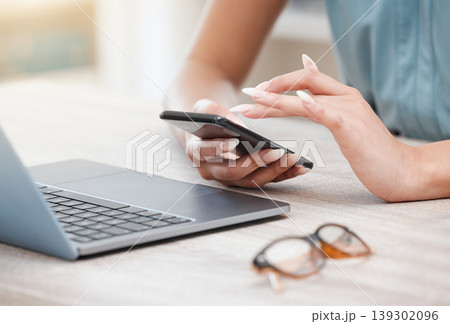 Hands, phone and a business woman at a desk in her office for communication, networking or search. Laptop, planning and glasses with an employee typing a text message closeup in the workplace 139302096