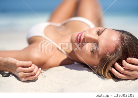 Woman, rest and beach in bikini sunbathing for summer tan, sand peace for outdoor vacation. Female person, relax at tropical paradise or coastal seaside trip for sunshine journey, island at ocean Woman, rest and beach in bikini sunbathing for summer tan, sand peace for outdoor vacation. Female person, relax at tropical paradise or coastal seaside trip for sunshine journey, island at ocean 139302105