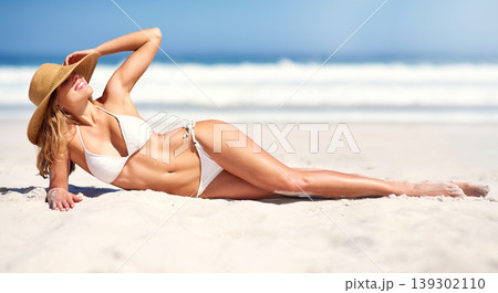 Woman, beach and bikini on sun tanning on holiday vacation, summer relax or ocean outdoor peace. Female person, hat and nature for confidence in clean air for weekend travel, water swimsuit in Bali Woman, beach and bikini on sun tanning on holiday vacation, summer relax or ocean outdoor peace. Female person, hat and nature for confidence in clean air for weekend travel, water swimsuit in Bali 139302110