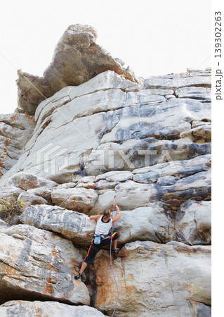 Woman, rock climbing and mountain or rope explore for grip strength, stone cliff or sports challenge. Female person, boulder hill and gear for outdoor peak safety or healthy fear, risk or fit danger 139302263