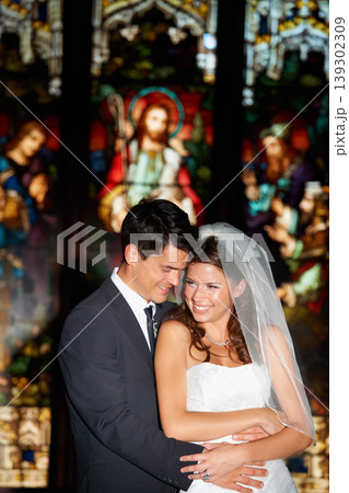 Happy couple, hug and wedding in church for marriage love or vow in commitment together. Married man or groom hugging woman or bride with smile for embrace, loyalty or support in trust at ceremony 139302309