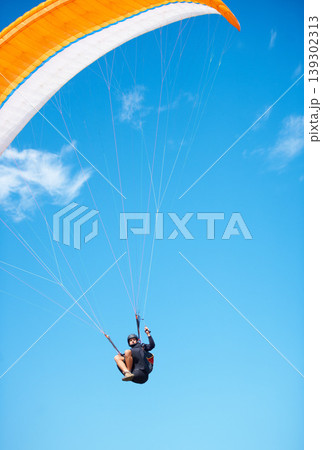 Man, paragliding and blue sky adventure fun in clouds for explore city, outdoor courage or fearless athlete. Male person, parachute and mockup space or safety equipment for landing, flying in nature Man, paragliding and blue sky adventure fun in clouds for explore city, outdoor courage or fearless athlete. Male person, parachute and mockup space or safety equipment for landing, flying in nature 139302313