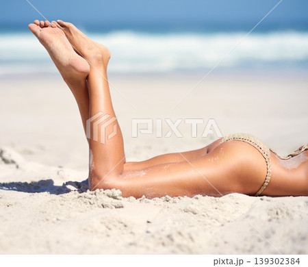Woman, legs and bikini on beach sand for relax vacation, sea resort for paradise travel. Female person, feet and swimsuit for outdoor costal trip for summer journey or tanning, clean air at ocean Woman, legs and bikini on beach sand for relax vacation, sea resort for paradise travel. Female person, feet and swimsuit for outdoor costal trip for summer journey or tanning, clean air at ocean 139302384