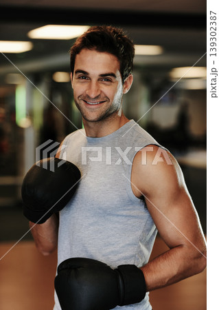 Man, boxing gloves and training with gym portrait with smile, wellness or exercise for fight, performance or sport. MMA, boxer and happy for contest, competition or workout for development with sweat Man, boxing gloves and training with gym portrait with smile, wellness or exercise for fight, performance or sport. MMA, boxer and happy for contest, competition or workout for development with sweat 139302387
