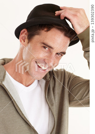 Fashion, happy and portrait of man in studio with hat for trendy clothes, accessory and style. Smile, closeup and face of isolated person with confidence, pride and happiness on white background Fashion, happy and portrait of man in studio with hat for trendy clothes, accessory and style. Smile, closeup and face of isolated person with confidence, pride and happiness on white background 139302390