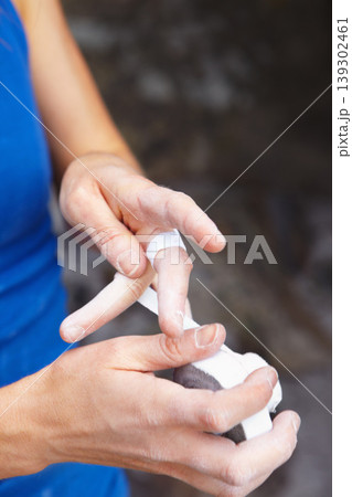 Person, hands and rock climbing or finger tape as grip strength, injury or support. Athlete, fingers and band aid or rope challenge or danger adventure on stone cliff or train gear, brave on mountain Person, hands and rock climbing or finger tape as grip strength, injury or support. Athlete, fingers and band aid or rope challenge or danger adventure on stone cliff or train gear, brave on mountain 139302461