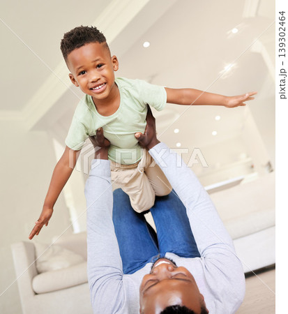 Airplane, smile and portrait of child with father in the living room of modern house having fun. Happy, love and young African boy kid playing with his dad on the floor of the lounge at home together Airplane, smile and portrait of child with father in the living room of modern house having fun. Happy, love and young African boy kid playing with his dad on the floor of the lounge at home together 139302464