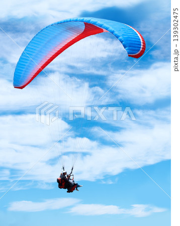 Man, parachute or paragliding in blue sky for adventure, flight freedom or courage with extreme sport. Pilot, nature and fearless in outdoor fitness for health, sports and wellness with glide in air 139302475