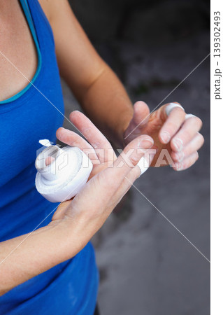 Person, fingers and tape for rock climbing outdoor injury, grip strength or bandage support. Athlete, hands or band aid for danger challenge or stone mountain safety as adventure, brave risk on cliff 139302493