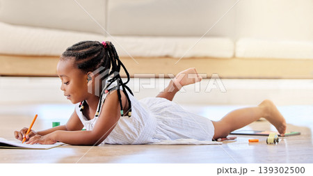 Child, book and colouring on floor, fun and learning for development, homework and playing at home. Black girl, education and creative project or art, notebook and homeschooling or happy drawing 139302500