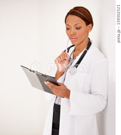 Woman, doctor thinking and medical charts for hospital schedule, management or results with solution or idea. African person reading of healthcare checklist, clipboard or folder on a wall background Woman, doctor thinking and medical charts for hospital schedule, management or results with solution or idea. African person reading of healthcare checklist, clipboard or folder on a wall background 139302521