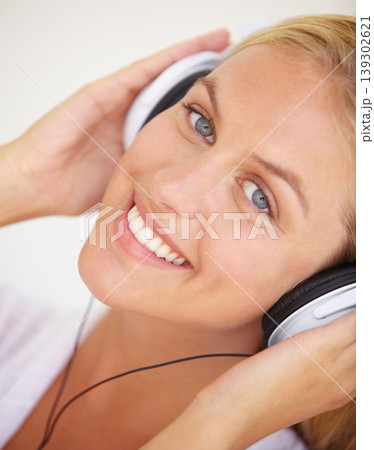 Portrait, happy woman and headphones for listening to music, freedom and wireless in closeup. Female person, face and smile with excitement for technology with podcast, radio or streaming service Portrait, happy woman and headphones for listening to music, freedom and wireless in closeup. Female person, face and smile with excitement for technology with podcast, radio or streaming service 139302621