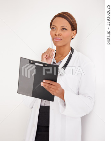 Woman, doctor thinking and healthcare charts for hospital schedule, management or results with solution or ideas. African person reading of medical checklist, clipboard or folder on a wall background 139302625