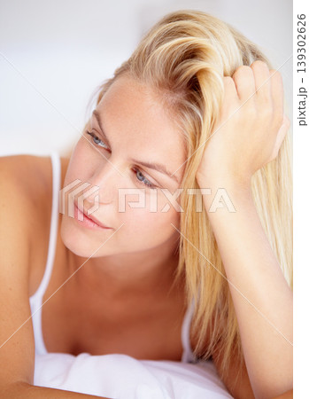Woman, thinking and lying on bed in closeup for relaxing, peaceful or calmness for quiet. Female person, idea or vision for resting, activity and alone with facial expression for wellness in home Woman, thinking and lying on bed in closeup for relaxing, peaceful or calmness for quiet. Female person, idea or vision for resting, activity and alone with facial expression for wellness in home 139302626