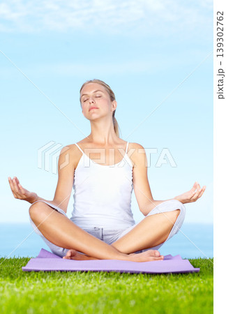 Woman, yoga and meditation in park for peace, calm and mental health or wellness and mindfulness. Young and zen person relax with outdoor lotus pose, spiritual care and chakra on blue sky background Woman, yoga and meditation in park for peace, calm and mental health or wellness and mindfulness. Young and zen person relax with outdoor lotus pose, spiritual care and chakra on blue sky background 139302762