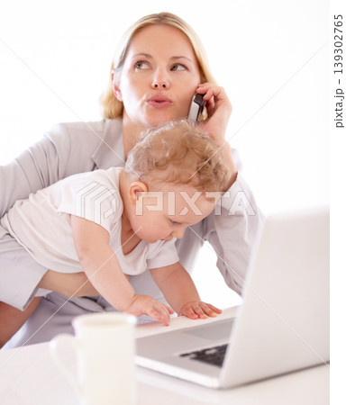 Businesswoman, phone call and baby with laptop in home for remote work, multitasking or productivity. Single mom, childcare and alone with busy toddler with stress for technology, career or job Businesswoman, phone call and baby with laptop in home for remote work, multitasking or productivity. Single mom, childcare and alone with busy toddler with stress for technology, career or job 139302765