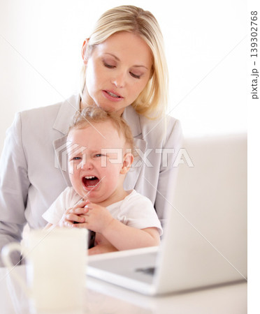 Businesswoman, crying and baby for remote work in home with laptop for multitask, productivity and job. Single mom, toddler and lap for comfort, childcare or love for freelance, development woking Businesswoman, crying and baby for remote work in home with laptop for multitask, productivity and job. Single mom, toddler and lap for comfort, childcare or love for freelance, development woking 139302768