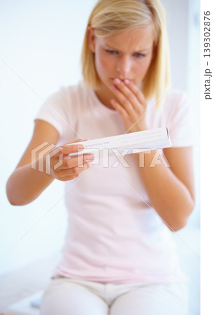 Anxiety, nervous and woman with pregnancy test in bathroom waiting for results, news and lines. Motherhood, pregnant and worried person with medical testing kit for fertility or ovulation at home 139302876