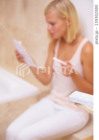 Reading, worry and woman with pregnancy test in bathroom waiting for results, news and instructions. Motherhood, pregnant and person with medical testing kit for fertility, ivf or ovulation at home Reading, worry and woman with pregnancy test in bathroom waiting for results, news and instructions. Motherhood, pregnant and person with medical testing kit for fertility, ivf or ovulation at home 139302880