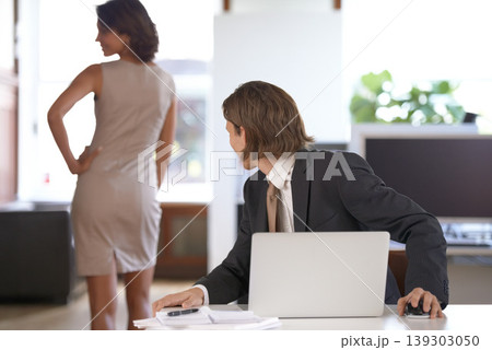 Ethics, sexual harassment and a business man in the office with a woman colleague. Fantasy, cheating or affair with a male employee looking at the back of a coworker in the corporate workplace 139303050